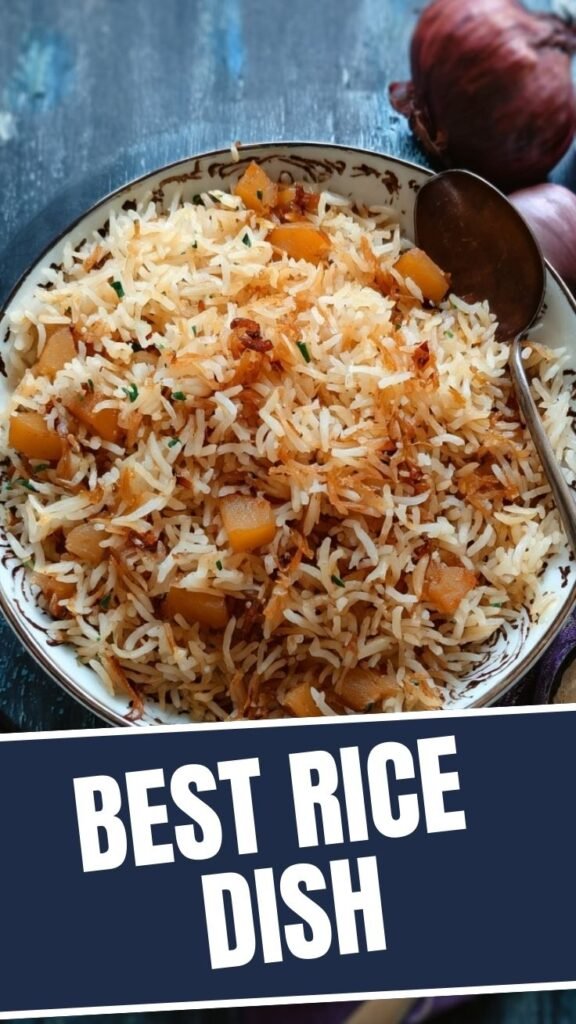 A serving of potato and onion rice in a white bowl, showing tender potatoes and caramelized onions.