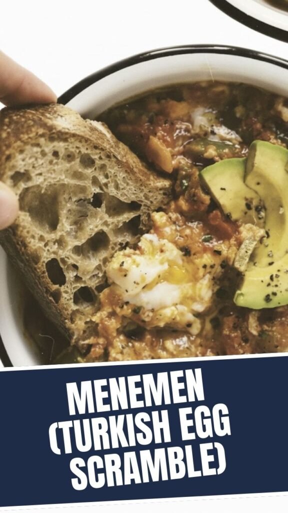 A vibrant Turkish menemen, a savory egg scramble, cooked in a pan.
