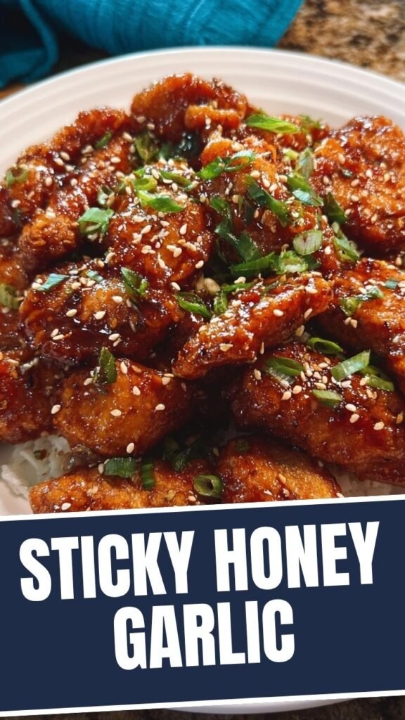 Close-up of golden brown honey garlic chicken with a glossy glaze.