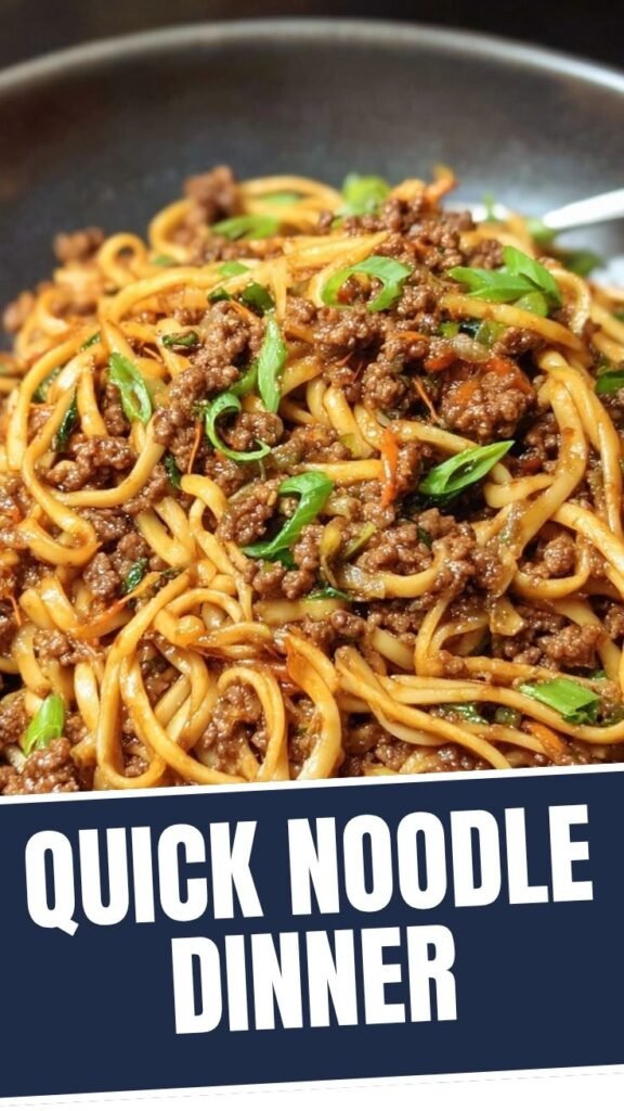 A close-up of Mongolian ground beef noodles in a bowl, ready to eat.
