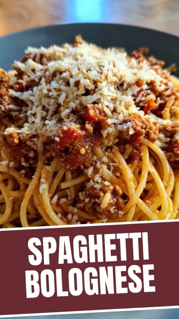 A steaming bowl of classic spaghetti bolognese with rich meat sauce.