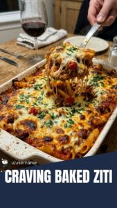 A bubbling casserole dish of baked ziti with melted cheese on top