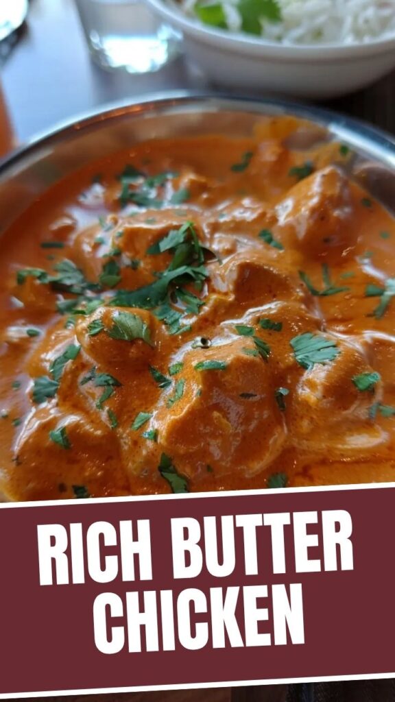 A bowl of rich and creamy butter chicken with naan bread.