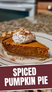 A freshly baked pumpkin pie with a golden-brown crust, ready to be served.