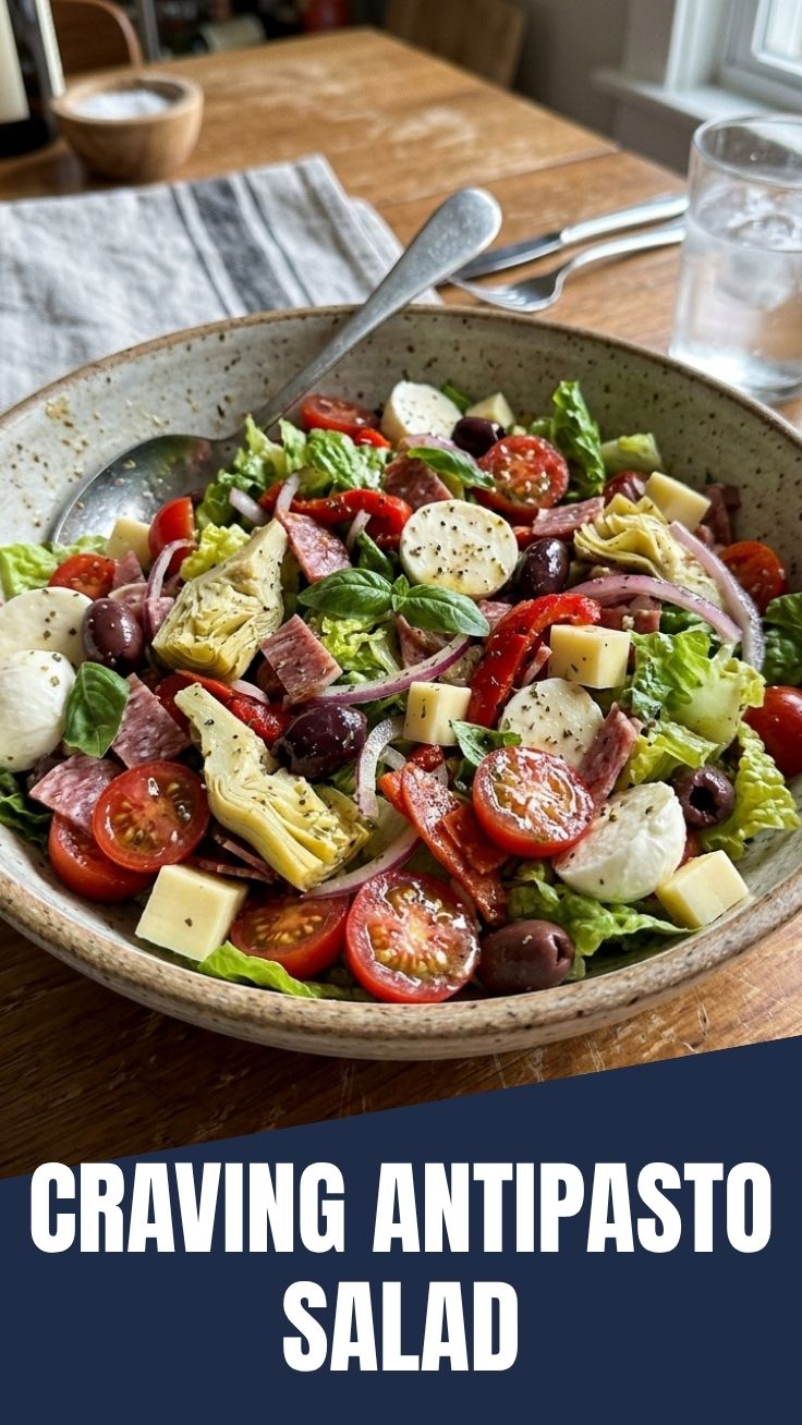 A colorful antipasto salad with various meats, cheeses, and vegetables.
