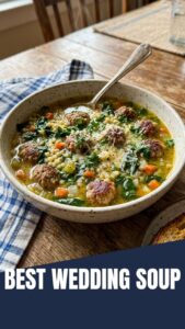 A steaming bowl of homemade Italian Wedding Soup with meatballs and greens.