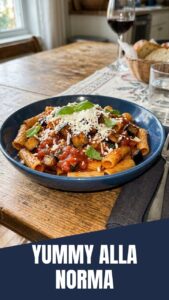 A vibrant bowl of Pasta alla Norma featuring tender eggplant and rich tomato sauce.