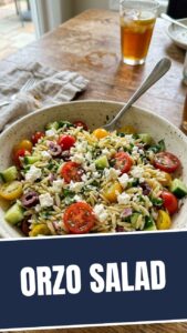 A vibrant and colorful summer orzo salad in a large bowl