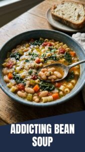 A rustic bowl of Tuscan white bean soup with fresh herbs and olive oil.