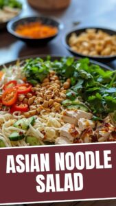 A vibrant bowl of Asian cold noodle salad with colorful vegetables and fresh herbs.