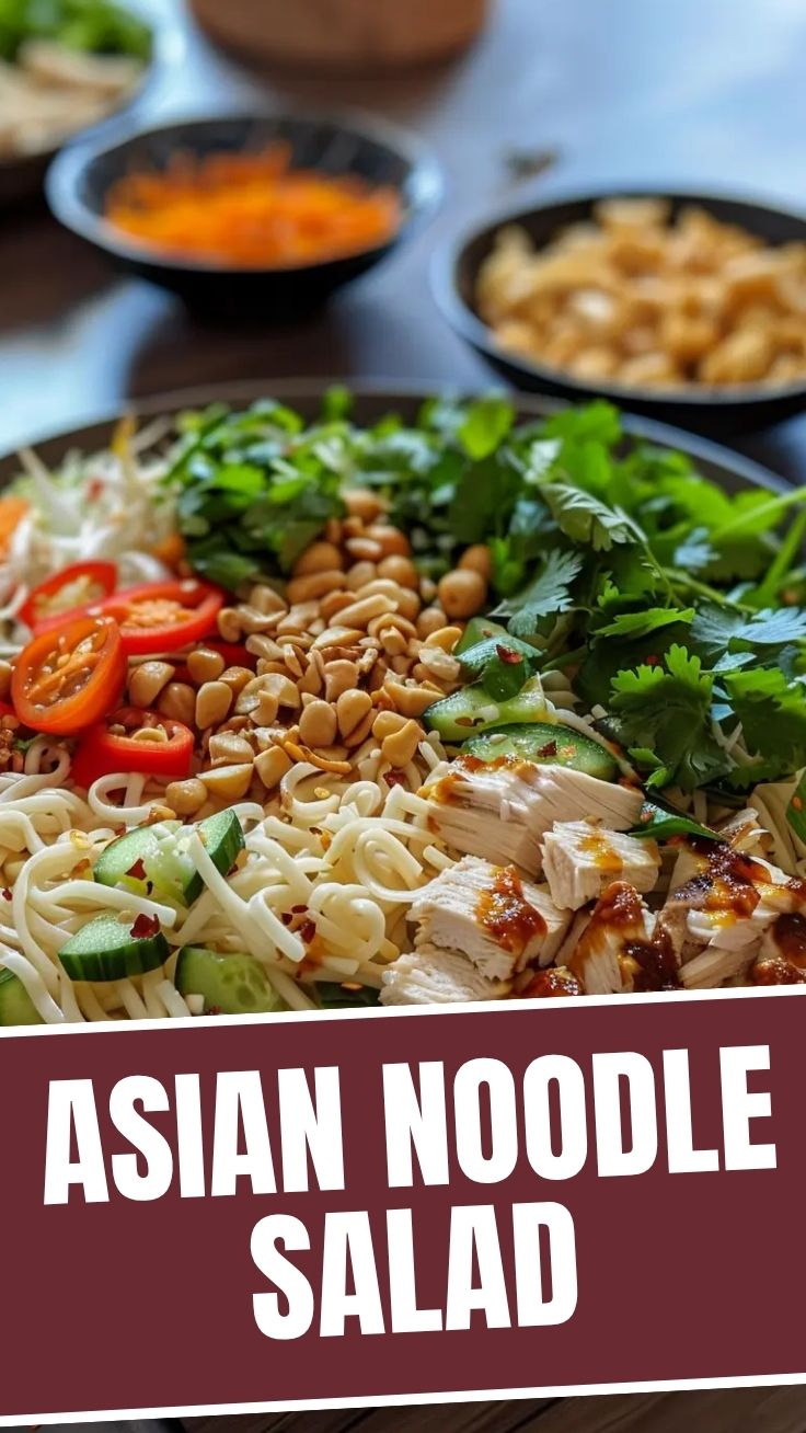 A vibrant bowl of Asian cold noodle salad with colorful vegetables and fresh herbs.
