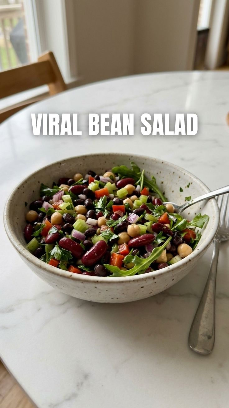 A vibrant bowl of fresh three bean salad with a light dressing.