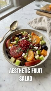 A colorful bowl of winter fruit salad featuring various seasonal fruits