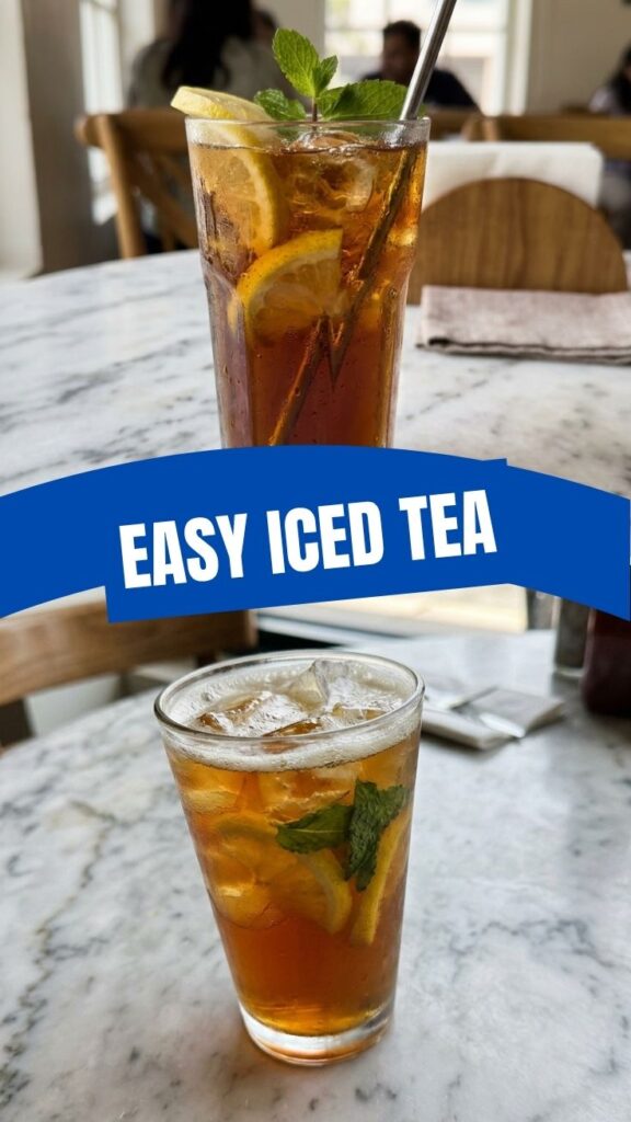 A tall glass of iced tea with lemon and ice cubes