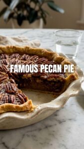A freshly baked whole pecan pie with a golden crust