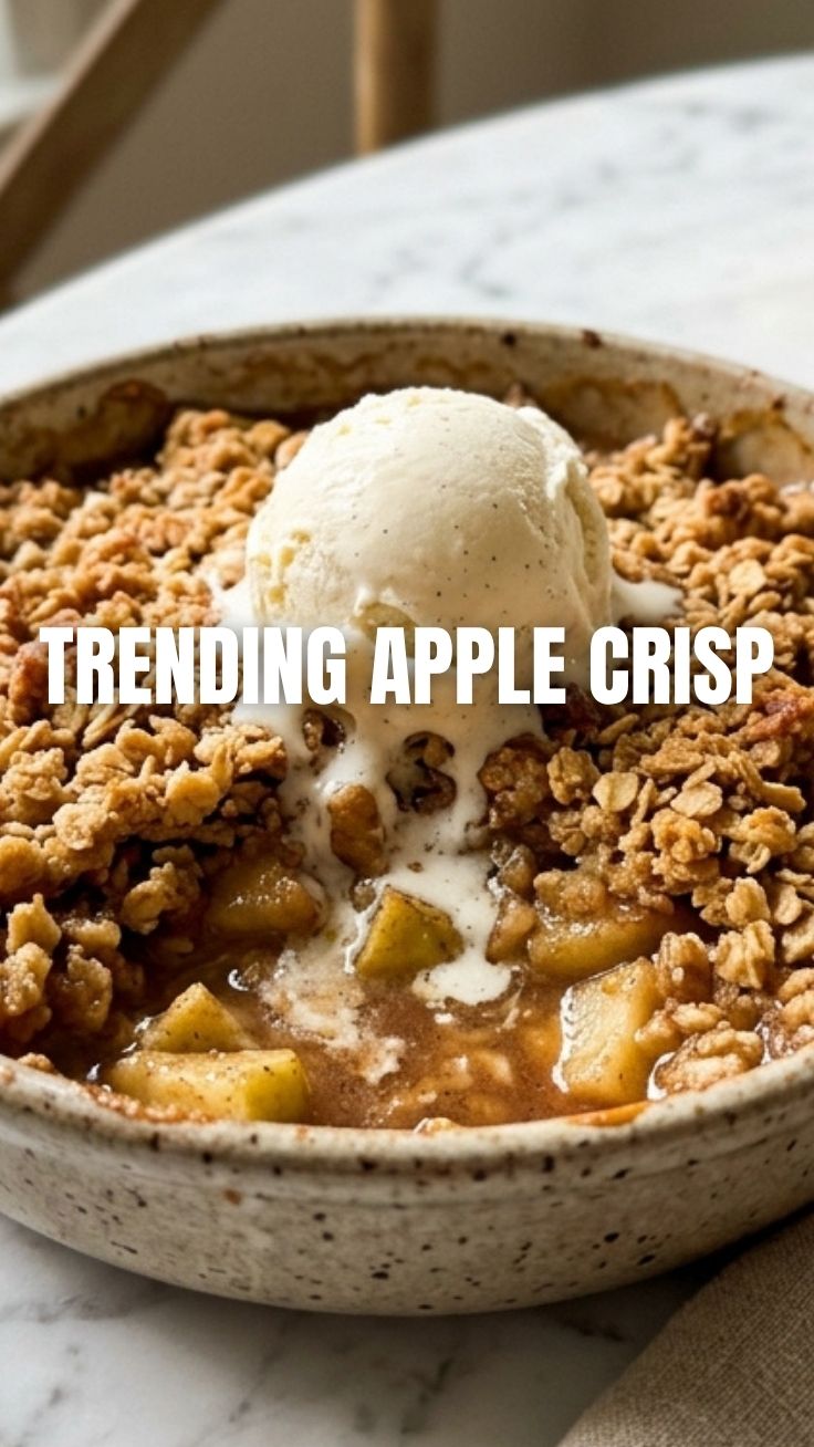 A freshly baked apple crisp with a golden brown topping, served warm.